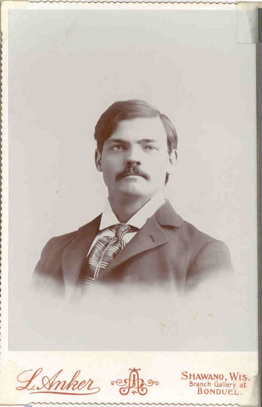 Studio portrait of Frederick Augustus Eberlein. Head and shoulders; taken by L Anker of Shawano, Wisconsin (branch studio at Bonduel). Probably taken in the 1890s.
